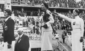 Helene Mayer on the podium at the Berlin Olympics, 1936. Helene was a German Jew. The authorities wanted to present a positive image of themselves to the world and Helene's participation was one way of doing that. She had little choice but to salute, the ramifications for her family would have been huge had she refused.